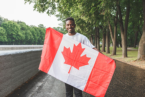 handsome-afro-american-man-with-canadian-flag Immigration Law