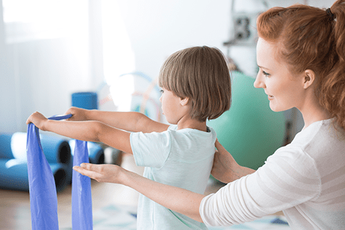 physiotherapist-supporting-kid-PFSENG9